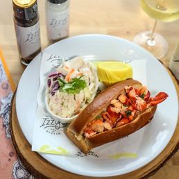 Izzy's Fish and Oyster signature dishes Lobster Roll (Connecticut-style or Maine-style), Oysters on the Half Shell, Clam Chowder, Fish & Chips